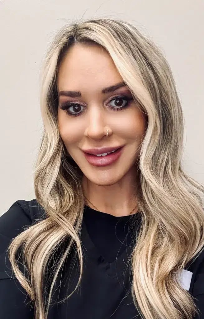 Kelly Gerloff, LPN, with long blonde hair, smiling